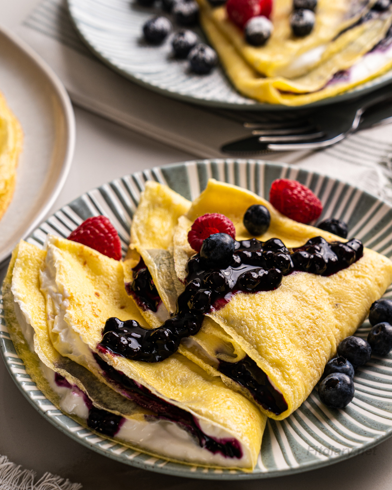 High protein crepes with Greek yogurt, blueberry sauce and berries