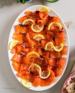 Fresh homemade cured salmon, sliced thinly on a platter for a healthy appetizer