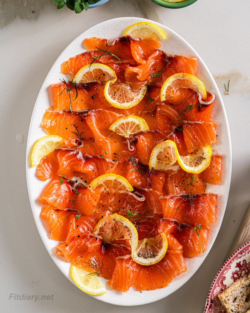 Fresh homemade cured salmon, sliced thinly on a platter for a healthy appetizer
