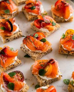 Cured salmon bites on mini canapés perfect for a healthy party appetizer