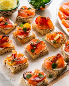 Healthy mini canapé toasts with gravlax and Greek yogurt spread for holidays and parties