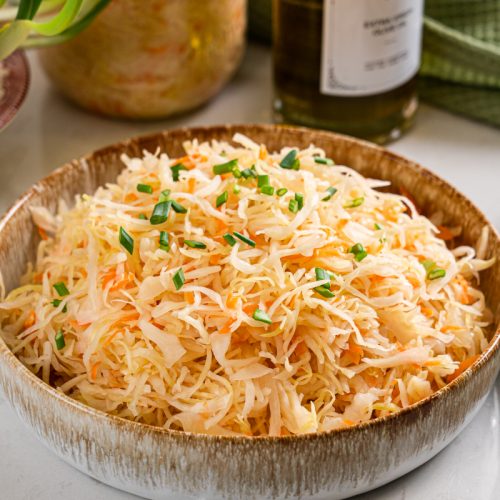 Homemade sauerkraut in a bowl showing a crunchy, naturally fermented cabbage texture
