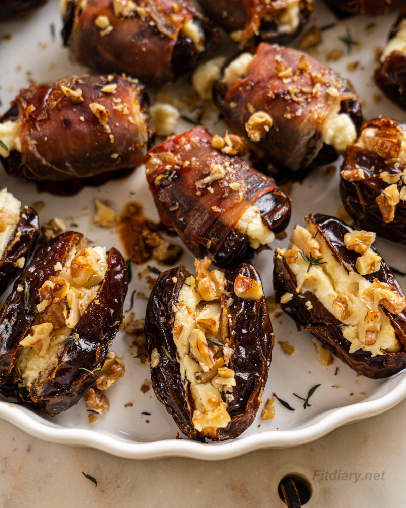 Close-up of low calorie cheese stuffed dates showing creamy filling and crunchy walnuts. Proscuitto wrapped dates stuffed with cheese.