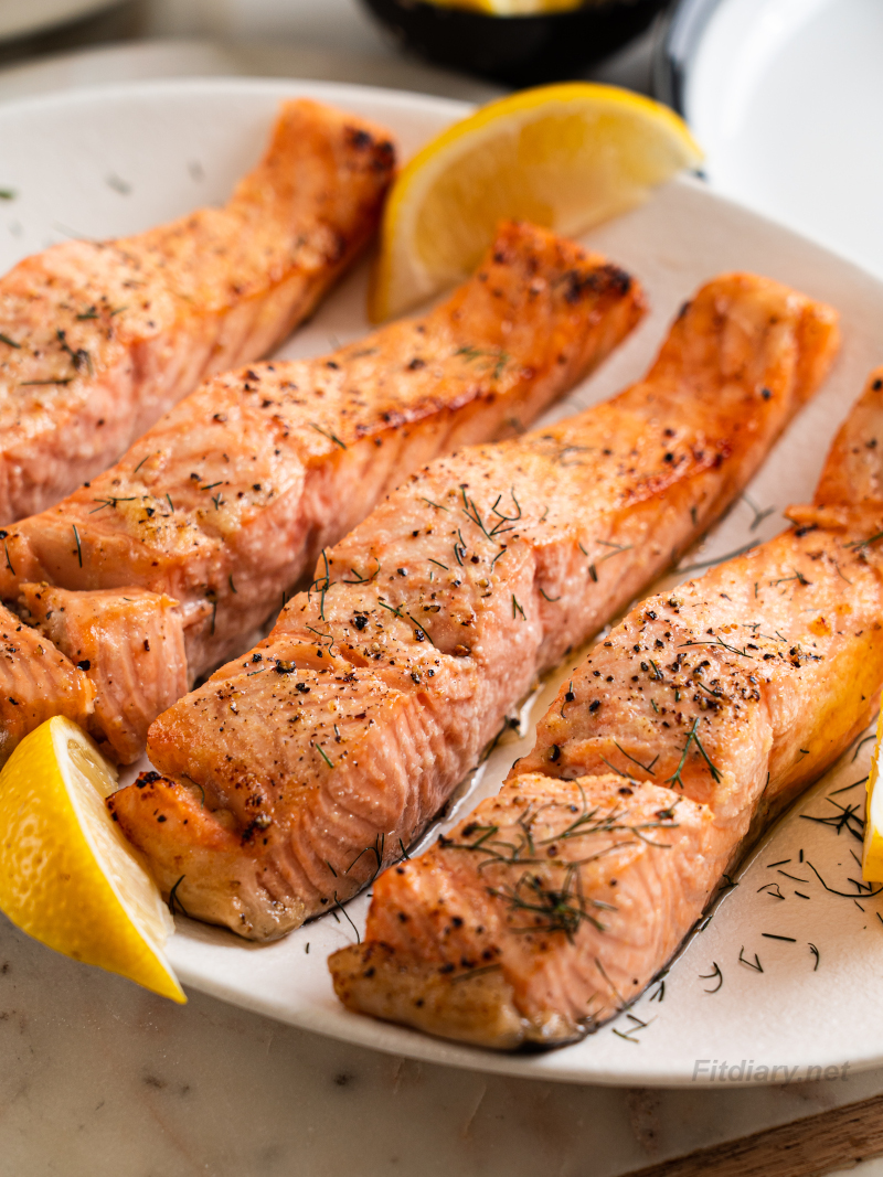 Close-up of perfectly cooked air fryer salmon with flaky texture and golden edges